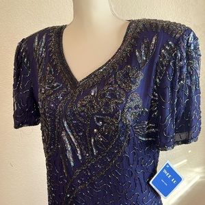Vintage, ornate  v-neck sequin dress with shoulder pads and loose short sleeves.